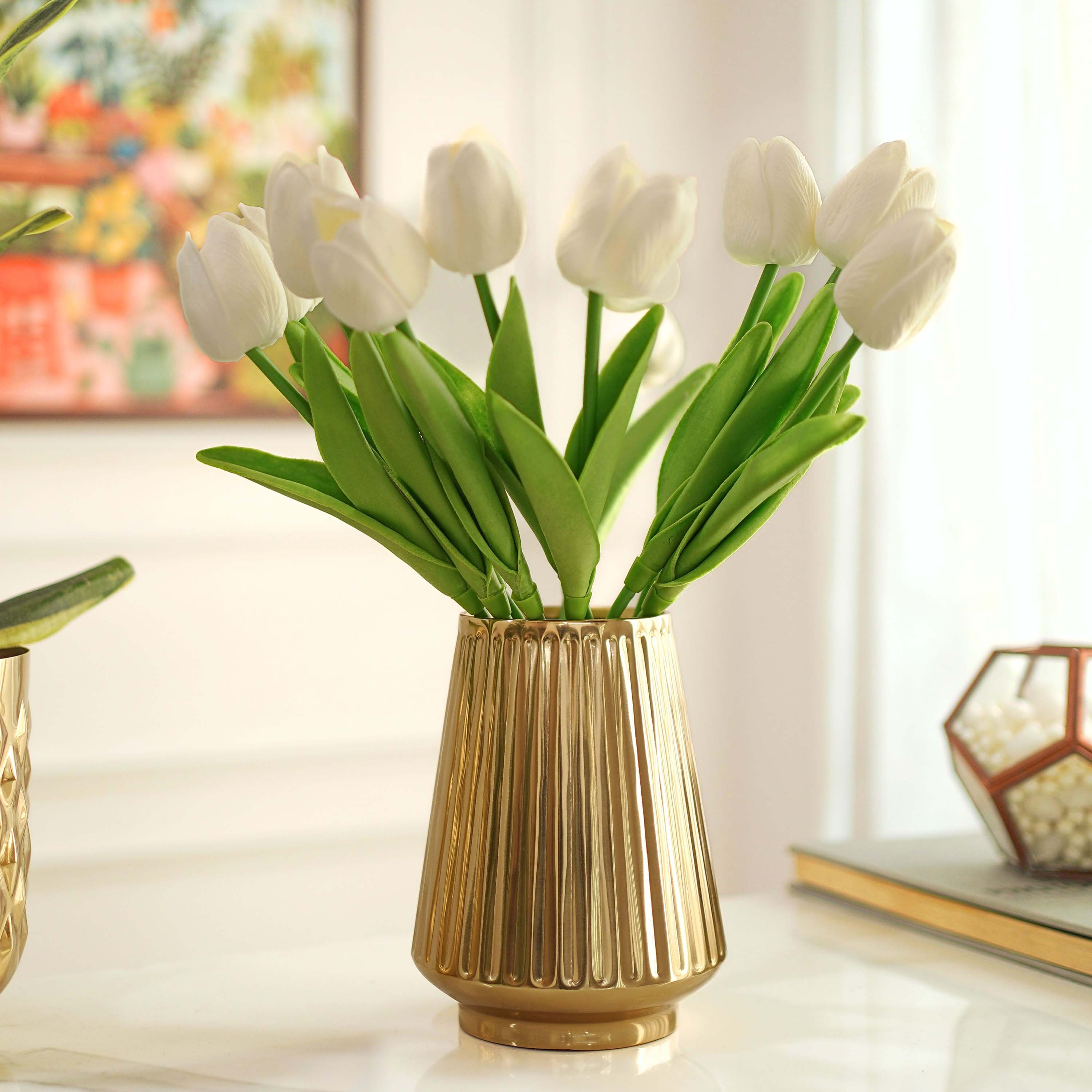 White tulips in a gold vase on a table with a blurred background, Fluted Skirt Flower Vase