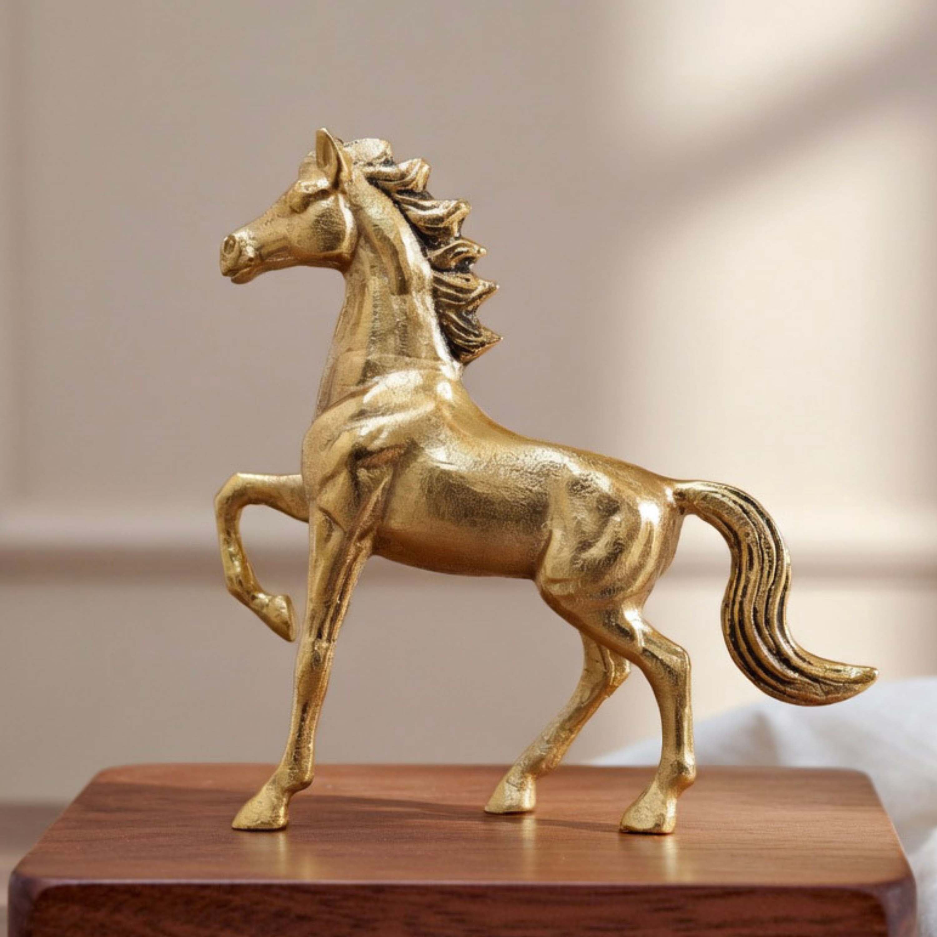 Gold horse statue on a wooden base against a neutral background, Horse Figurine
