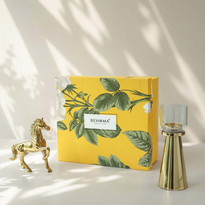 Yellow decorative box with green leaf pattern and 'BEHOMA' branding, accompanied by a gold horse figurine and candle holder on a light background, Royal Glow Gift Set