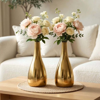Two gold vases with floral arrangements on a wooden table in a living room setting, Teardrop Flower Vase Set